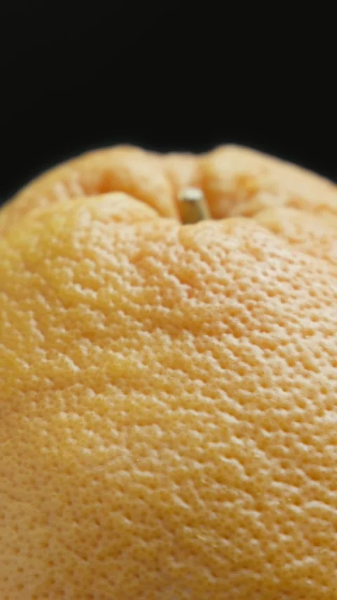 Fresh grapefruit rotating at black background. Organic healthy food concept. Stockbeeldmateriaal 329436907