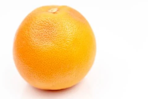 Fresh Grapefruit on the white reflective surface with copy space Stock Photos