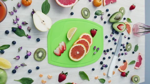 Fresh grapefruits on cutting board surrounded by fruits Stock Footage 229843498