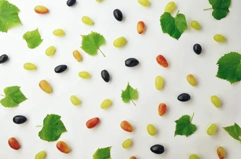 Fresh grapes on a light background. Light summer or autumn fruit texture. H.. Stock Photos