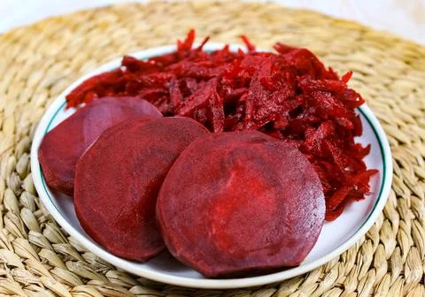 Fresh grated beets in a plate. Beetroot salad with raw vegetables. Stock Photos