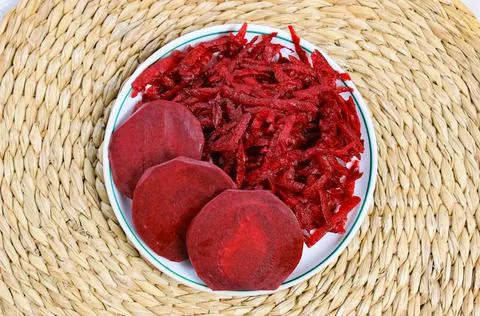 Fresh grated beets in a plate. Beetroot salad with raw vegetables. Stock Photos