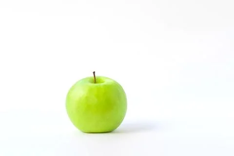 Fresh green apple on clear solid and white background in studio light. Stock Photos