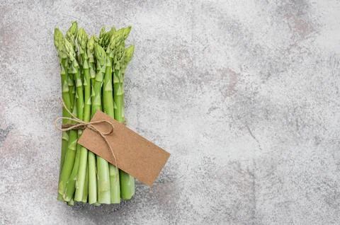 Fresh green asparagus on  concrete background. Stock Photos