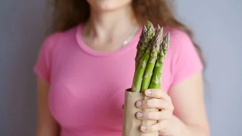 Fresh green asparagus in a woman's hands Stock Footage