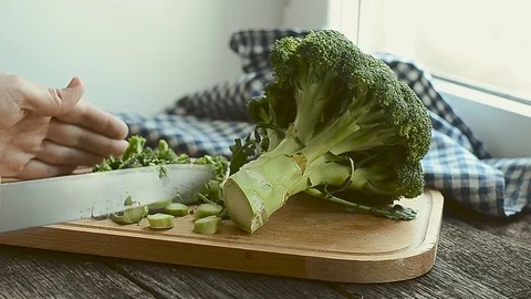 Fresh green broccoli being chopped into pieces, closeup. Stock Footage 74663408