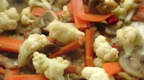 Fresh green broccoli chunks dropping onto stir-fry with vegetables and mixed  Stock Footage 68936583