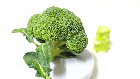 Fresh green broccoli crown with cut stalk isolated on white background. 스톡 동영상 339331758