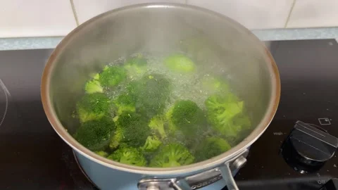 Fresh Green Broccoli Florets Boiling in Steaming Pot on Stove Stock Footage 345015693
