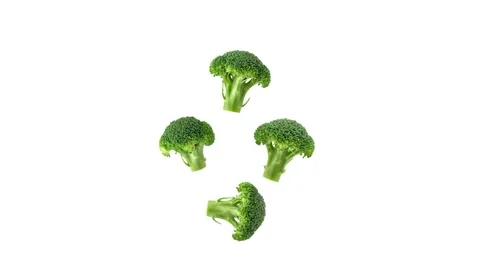 Fresh green broccoli florets with thick stems floating isolated on white Stock Footage 339340978