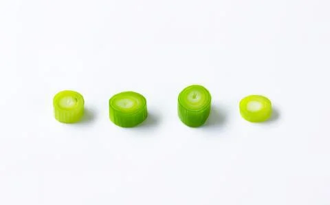Fresh green celery slices on plain surface Stock Photos