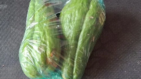 Fresh green chayote squash packed inside plastic bag video footage Stock Footage 339374485