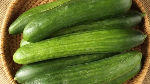 Fresh green cucumbers rotating in a basket Stock-Footage 336464334