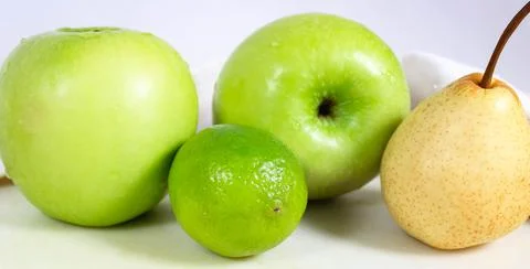 Fresh green fruit close-up on the table. The concept of diet and healthy eating. Stock Photos