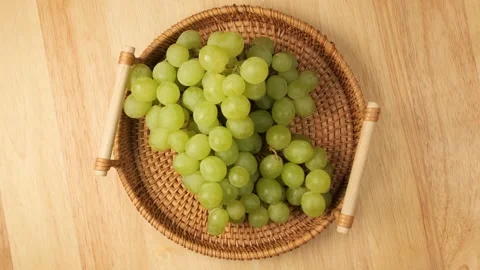 Fresh green grapes rotating in a wicker basket Stock Footage 341281036
