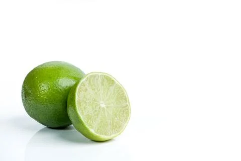 Fresh green lime cut in half with whole fruit on white background 스톡 사진