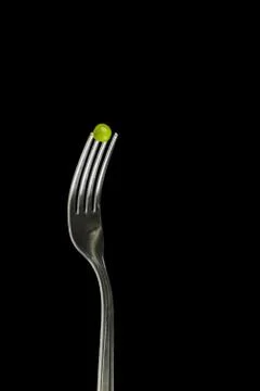 Fresh green peas on a silver fork Stock Photos
