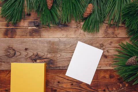 Fresh green pine tree branches and fir cones on wooden background, top view Stock Photos