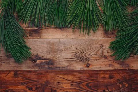 Fresh green pine tree branches on wooden background, top view, copy space Stock Photos
