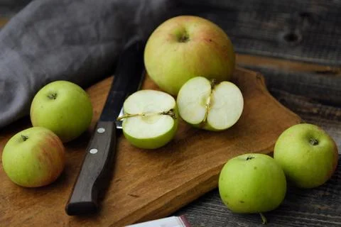 Fresh green rustic apples on a grey background Stock Photos