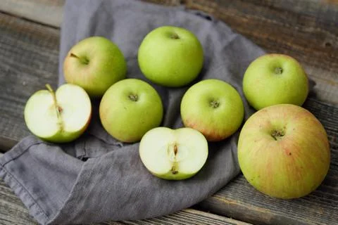 Fresh green rustic apples on a grey background Stock Photos