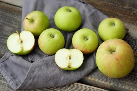 Fresh green rustic apples on a grey background Stock Photos