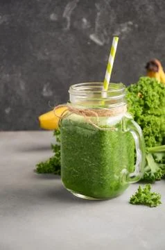 Fresh green smoothie with kale and banana in a jar. Stock Photos