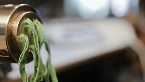 Fresh green spaghetti pasta with spinatte coming out of pasta machine, close up Stock Footage 134681510