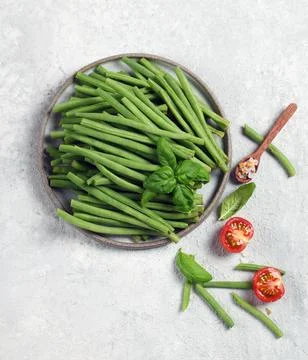 Fresh green string beans in a gray plate on a light gray background top view Stock Photos