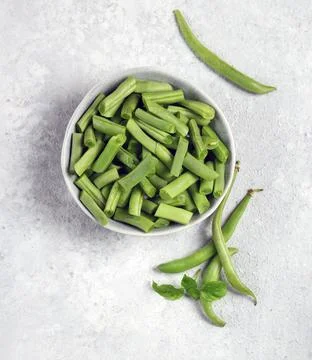 Fresh green string beans in a gray plate on a light gray background top view Stock Photos