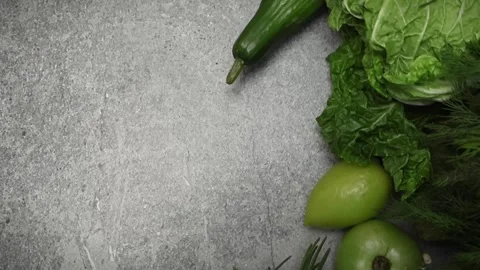 Fresh green vegetables on concrete surface Stock Footage 294750677