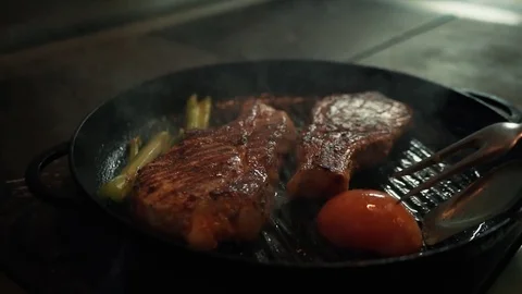 Fresh grilled meat with vegetables. Chef cooking delicious steak in a pan. Tasty Stock Footage 85144073