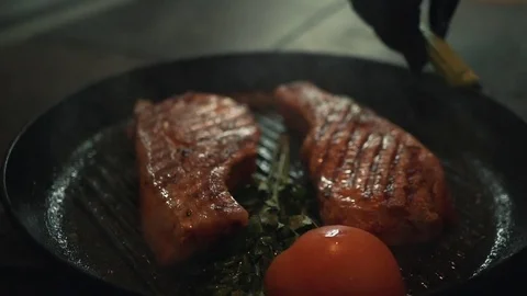 Fresh grilled meat with vegetables. Chef cooking delicious steak in a pan. Tasty Stock Footage 85145457