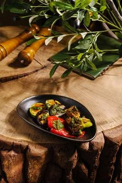 Fresh grilled vegetables served on a rustic wooden table Stock Photos