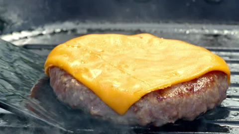 Fresh ground beef burger patty with cheese fried on a pan. Street food. Stock Footage 315902865