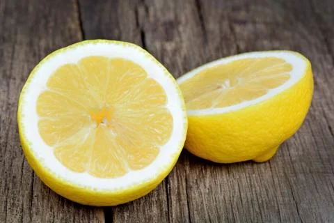 Fresh half lemon on a rustic table Stock Photos