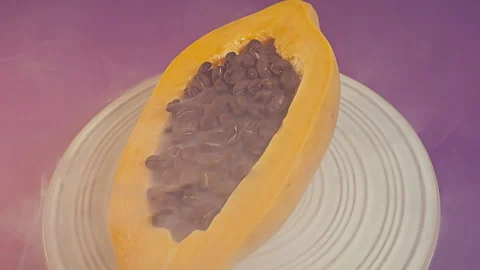 Fresh Halved Papaya Filled with Roasted Coffee Beans Stock-Footage 344985688