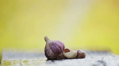 Fresh head of garlic on a table under a stream of water. Stock Footage 114443682