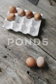 Fresh Hen's Eggs In A Box And On A Wooden Table.