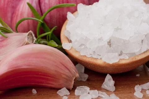 Fresh herbs and salt spoon Stock Photos
