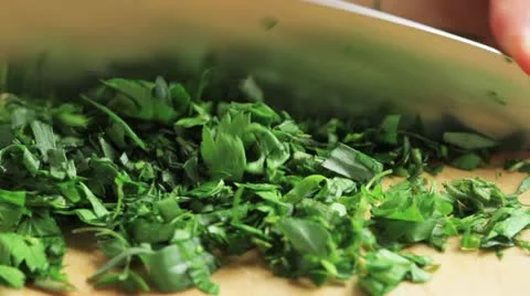 Fresh herbs being chopped Stock Footage 24673100