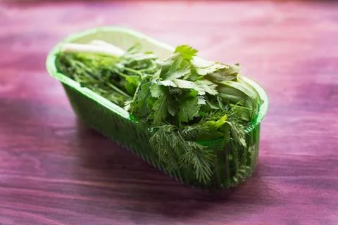 Fresh herbs in plastic container Stock Photos