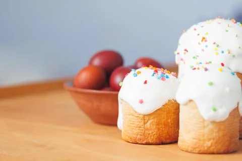 Fresh homemade Easter bread paska with sugar glaze and colorful eggs Stock Photos