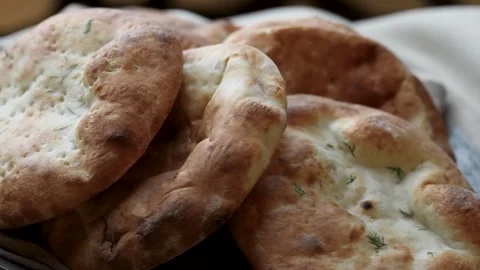 Fresh Homemade Naan Flatbread with Dill on Linen Cloth. Stack of baked flat.. Video stock 331215249