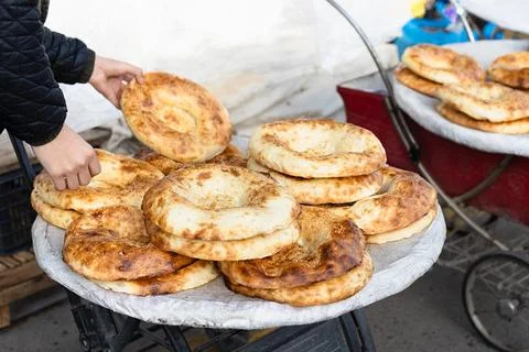Fresh hot flatbreads piled high on street vendor tray. Golden crusty  fresh.. Stock Photos