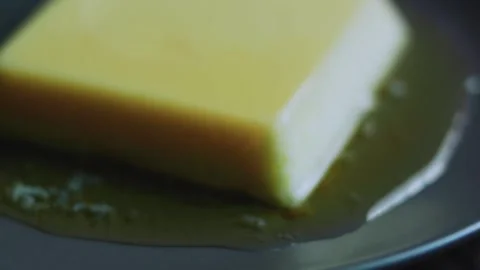 Fresh ingredient study of square flan surrounded by glossy caramel sauce Stock Footage 342154074