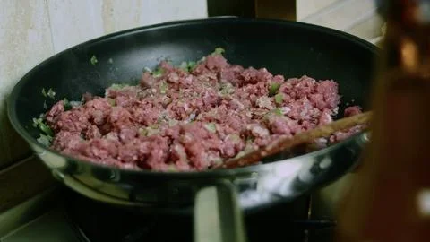 Fresh ingredient view of ground beef browning in a skillet Stock Photos