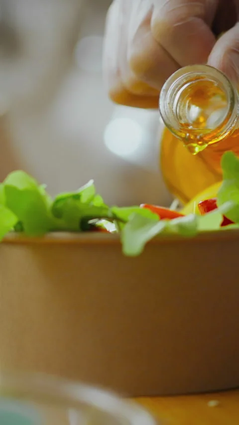 Fresh ingredients are being prepared for a colorful salad in a bright kitche Stock Footage 331583353