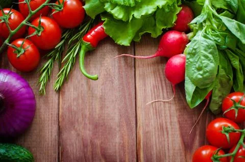 Fresh ingredients for cooking in rustic setting: Salad, radish, Onion, corn Stock Photos