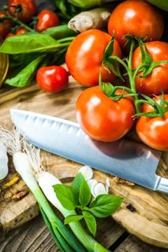 Fresh ingredients for cooking in rustic setting: tomatoes, basil, olive oil,  Stock Photos
